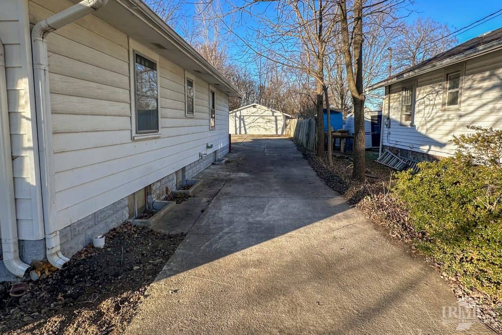 Outdoor view of rental homes in Muncie, Indiana with driveway and backyard.