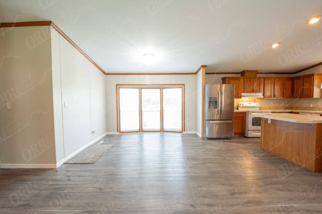 Spacious kitchen and living space in Muncie rental home featuring stainless appliances and large window.